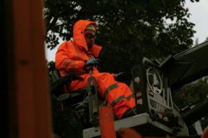 Worker operating land clearing vehicle.